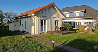 Close to the beach holiday home in a quiet field location with a spacious wooden terrace