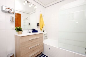 Bathtub, eco-friendly toiletries, hair dryer, towels