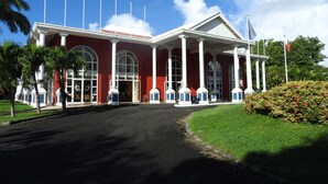 A large, red building with white columns and arched windows.
