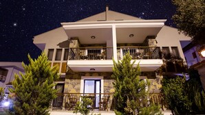 A two-story building with a balcony on the upper floor, surrounded by trees. - Pharos Hotel (Datça)