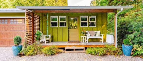 A house with a covered porch, a garage, and a front door.