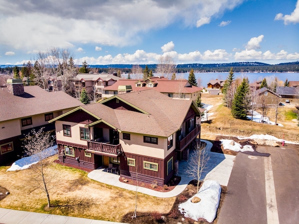 A residential area with houses, a clear sky, and a lake in the background.