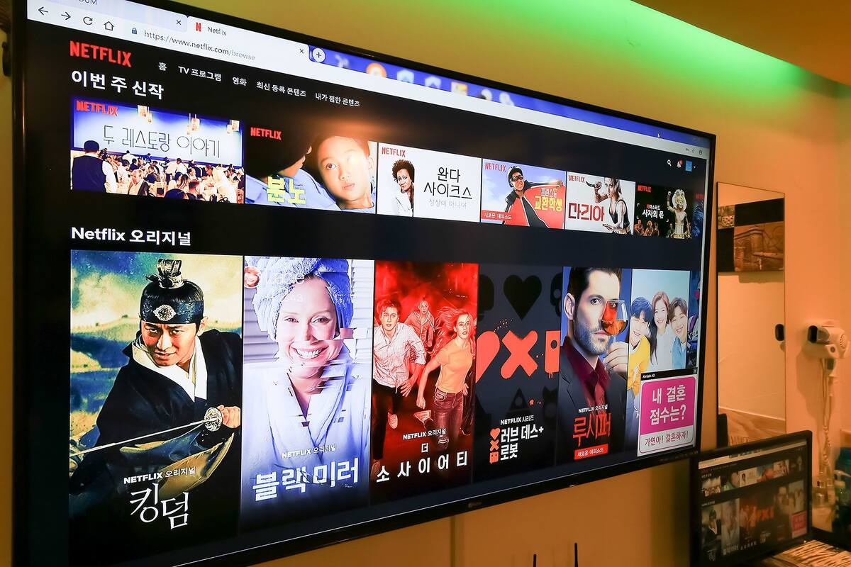 A large screen displaying various Netflix movie posters.