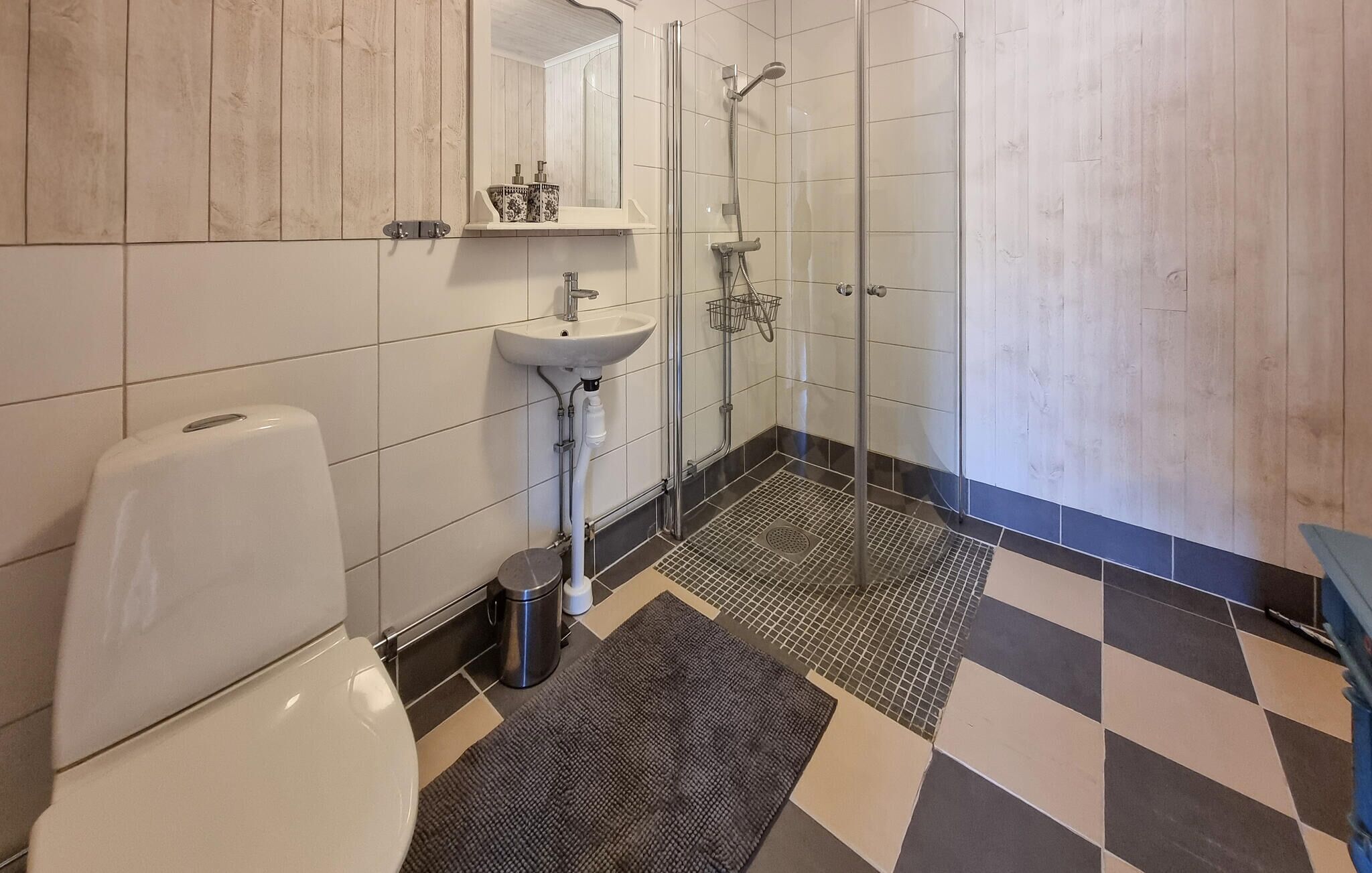 Un baño con inodoro, lavamanos y ducha.