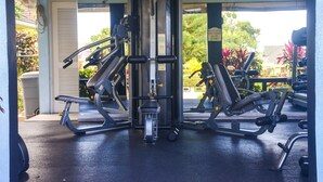A gym with various exercise machines, a covered area, and a view of greenery outside. - Tranquillity at The Palms (St. Ann's Bay)