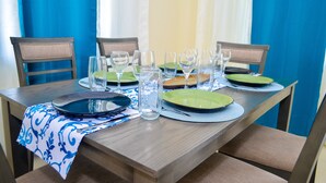 A dining table set with plates, glasses, and a vase. - Tranquillity at The Palms (St. Ann's Bay)