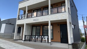 A two-story building with a stone facade, a balcony on the upper floor, and a sign reading "Diamond Dust." - Diamond Dust Furano (Furano)