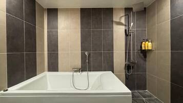 Suite, Jetted Tub | Bathroom | Free toiletries, hair dryer, bathrobes, slippers