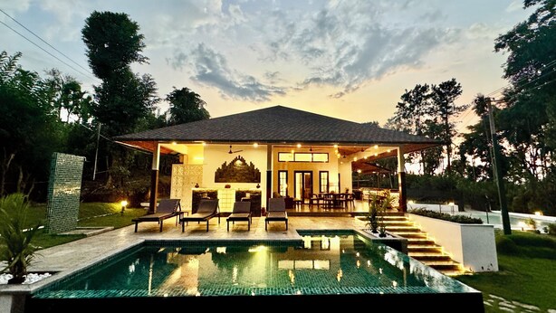 A house with a swimming pool, outdoor seating, and a covered patio area. - Tranquil Resort - BluSalzz Collection, Wayanad (Sulthan Bathery)