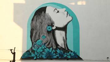A wall mural of a woman with a flower.