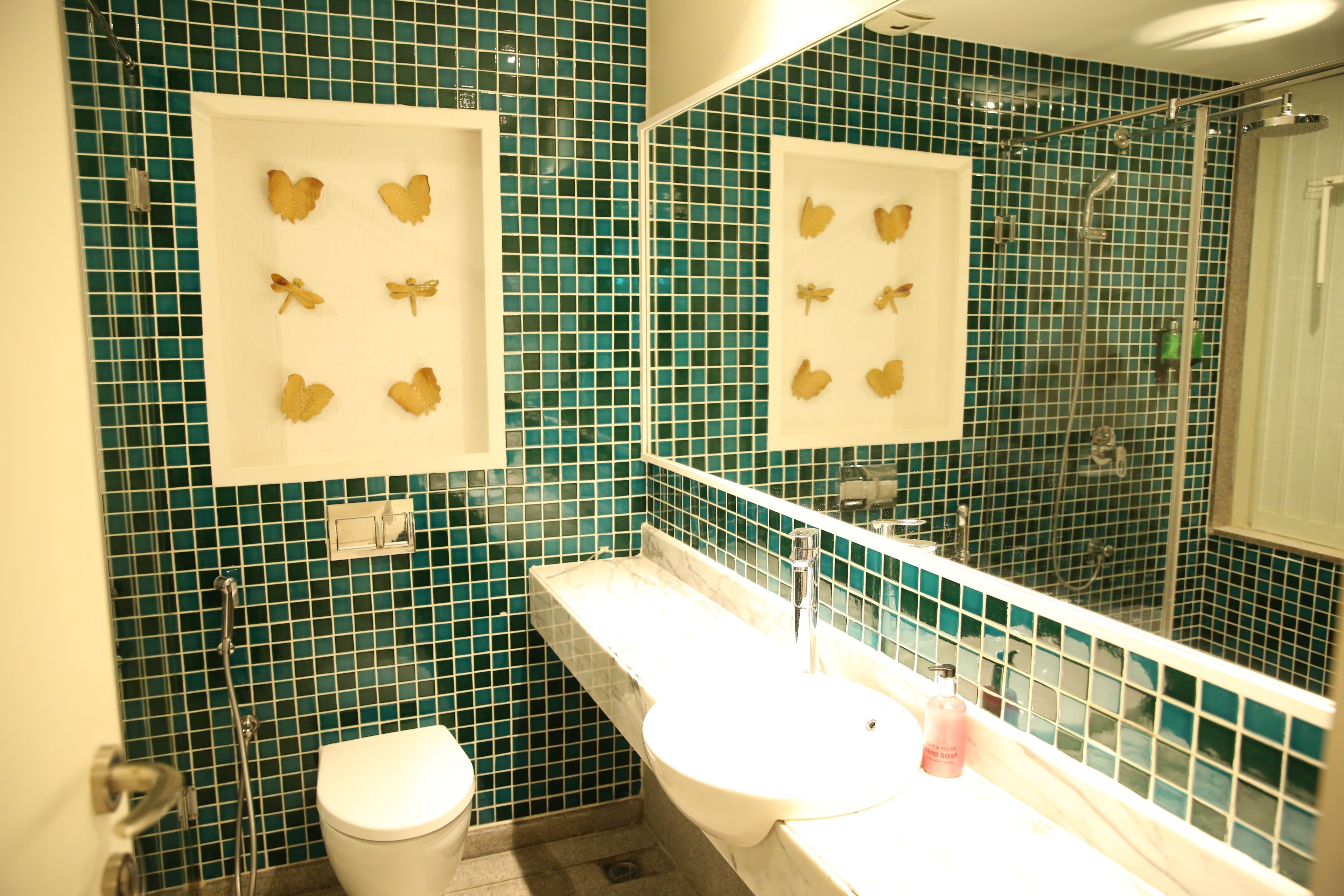 A bathroom with a white sink, a toilet, and a shower with a glass door.