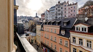 A cityscape with historic buildings, including a church with a dome, and a variety of architectural styles. - Apartments Menuet (Karlovy Vary)