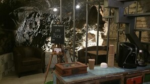 A rustic interior with a vintage wooden desk, a leather chair, and a chalkboard sign. - 5 Terre Pelagos 2 (Riomaggiore)