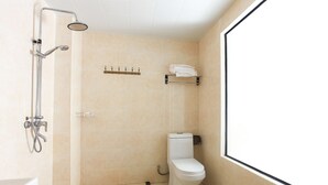 A small, modern bathroom with a shower, toilet, and towel rack. - Wuyishan City Chun Hui Traders Hotel (Nanping)