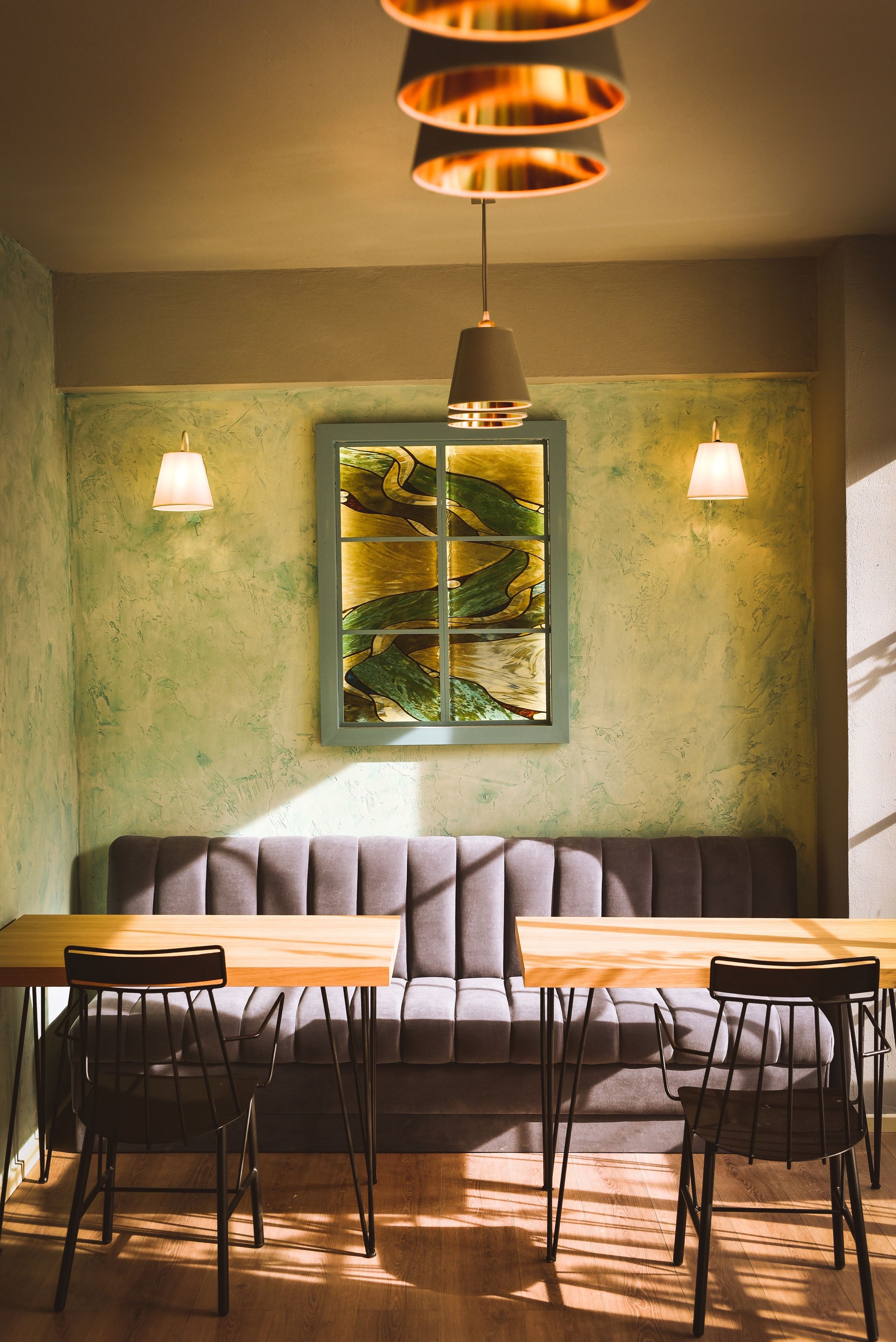 A dining area with a wooden table, cushioned bench, and two chairs.