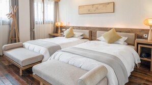 A hotel room with two beds, wooden headboards, and a large window with curtains. - Zitaoxuan Inn (Jiaxing)