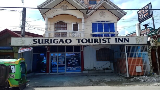 A two-story building with a sign reading "Surigao Tourist Inn". - Surigao Tourist Inn Main (Surigao)