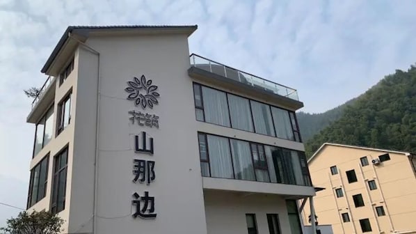 A building with a modern design, featuring a prominent logo and the name 'Mountain Edge' on the facade.