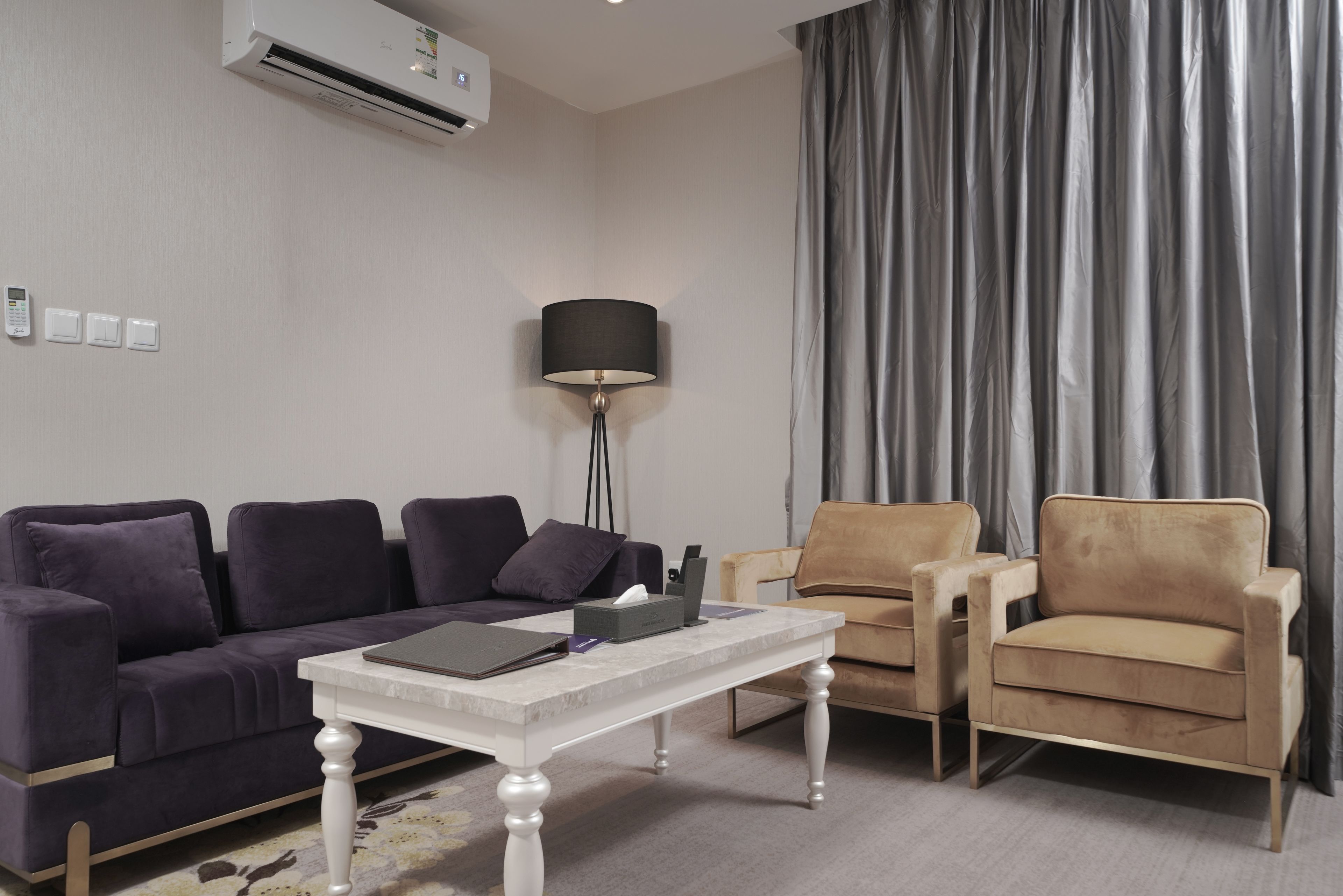 A modern living room with a sofa, armchair, and a coffee table.