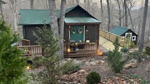 A cabin with a porch, a deck, and a small garden area. - Lakeside Retreat Lake Lanier-Enjoy fall with amazing hiking and wineries! (Dawsonville)