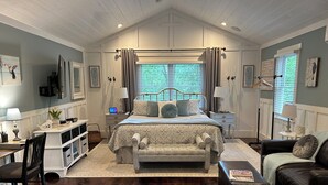 A bedroom with a bed, bedside tables, a desk, a chair, a sofa, and a window with curtains. - Lakeside Retreat Lake Lanier-Enjoy fall with amazing hiking and wineries! (Dawsonville)
