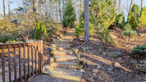A wooden staircase leading up a hill, surrounded by trees and rocks. - Lakeside Retreat Lake Lanier-Enjoy fall with amazing hiking and wineries! (Dawsonville)