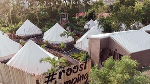 A row of white tents with a bamboo fence and a sign that reads "#roost glamping". - Roost Glamping (Rawai)