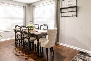 Enjoy meals in this dining area with a wooden table and six comfortable chairs.