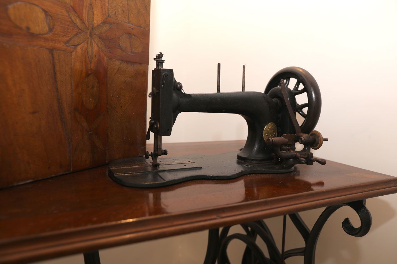 An antique sewing machine on a wooden table.