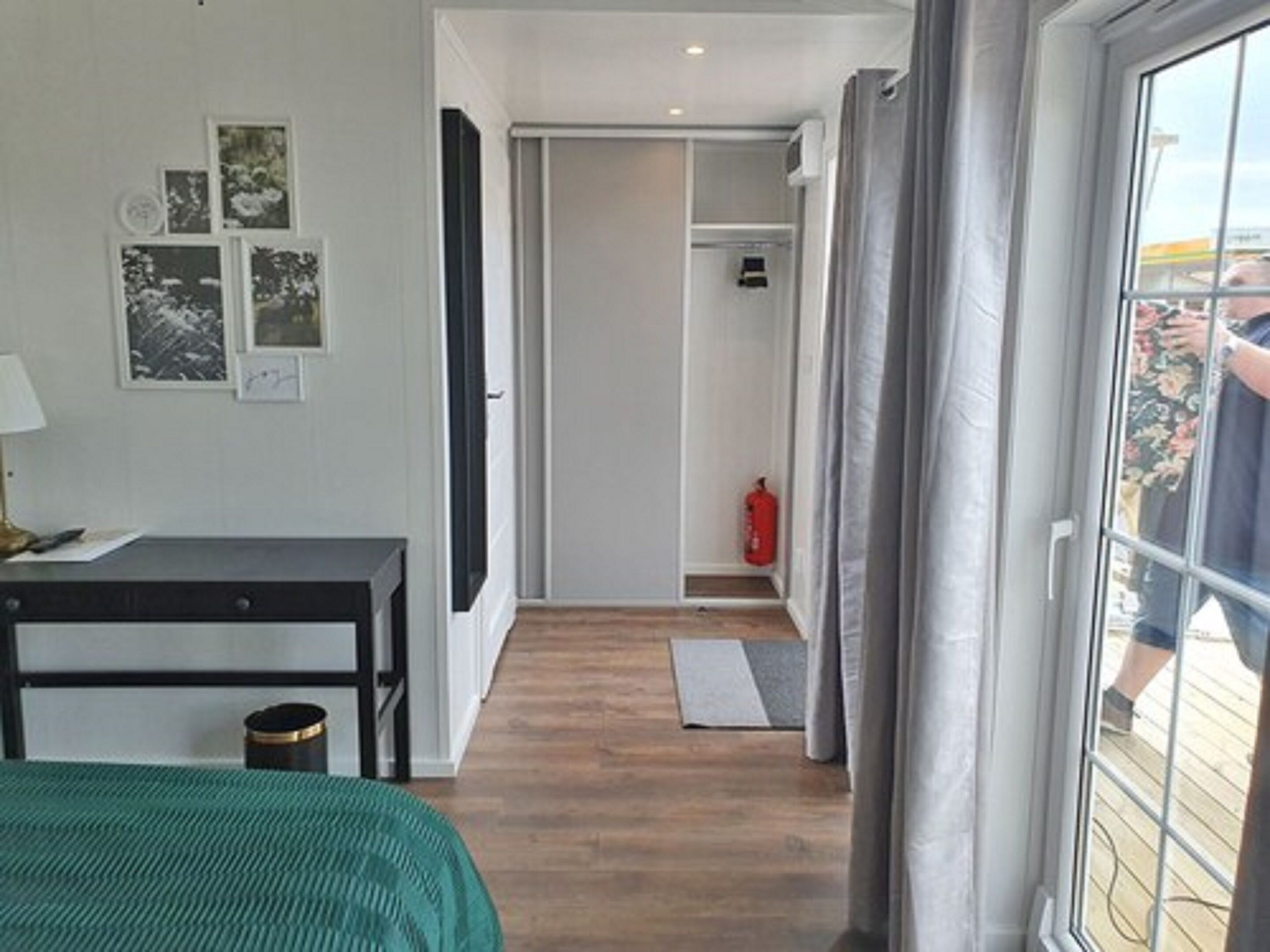 desk, laptop workspace, iron/ironing board, bed sheets