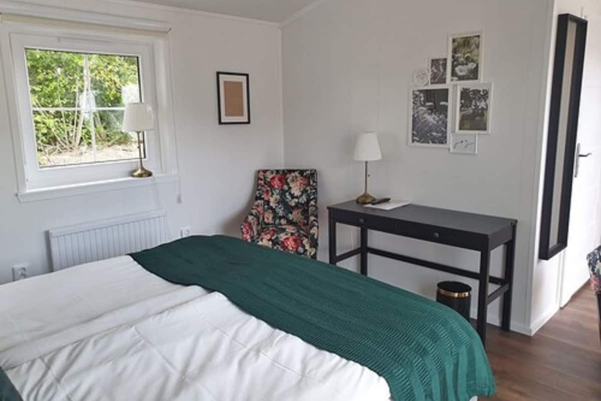 desk, laptop workspace, iron/ironing board, bed sheets