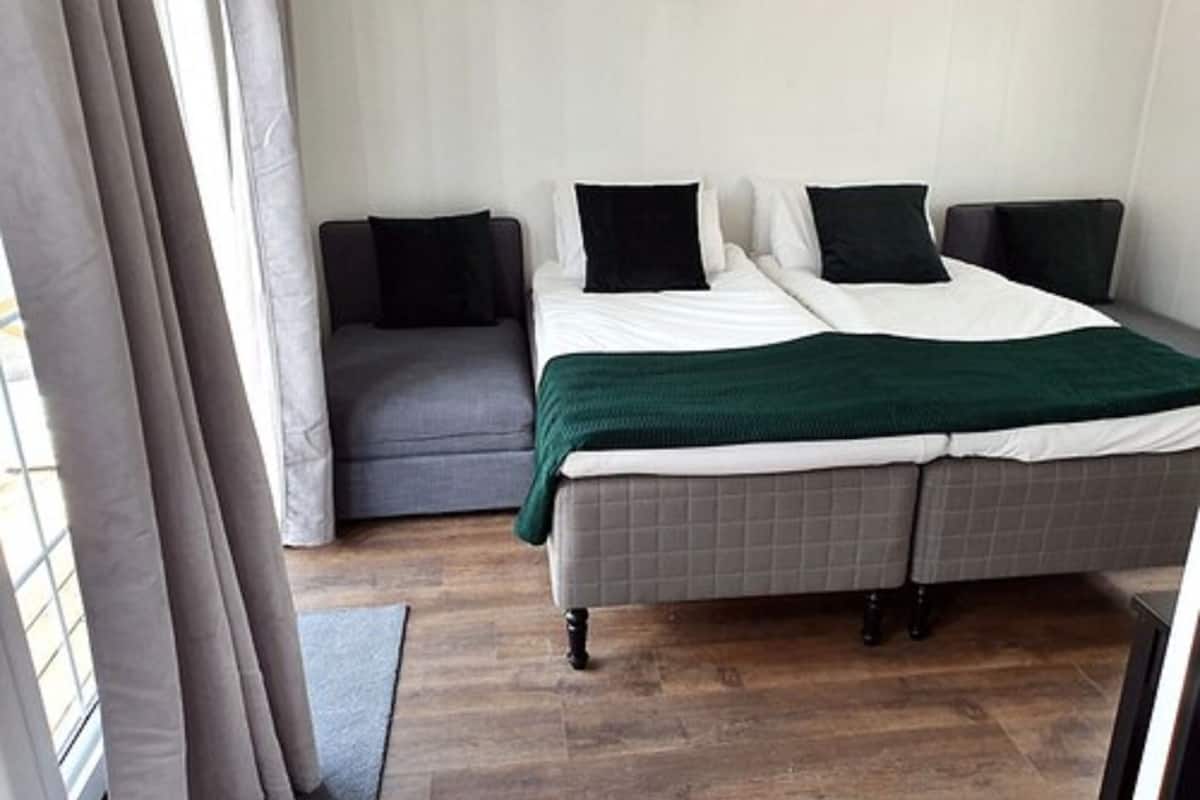 desk, laptop workspace, iron/ironing board, bed sheets