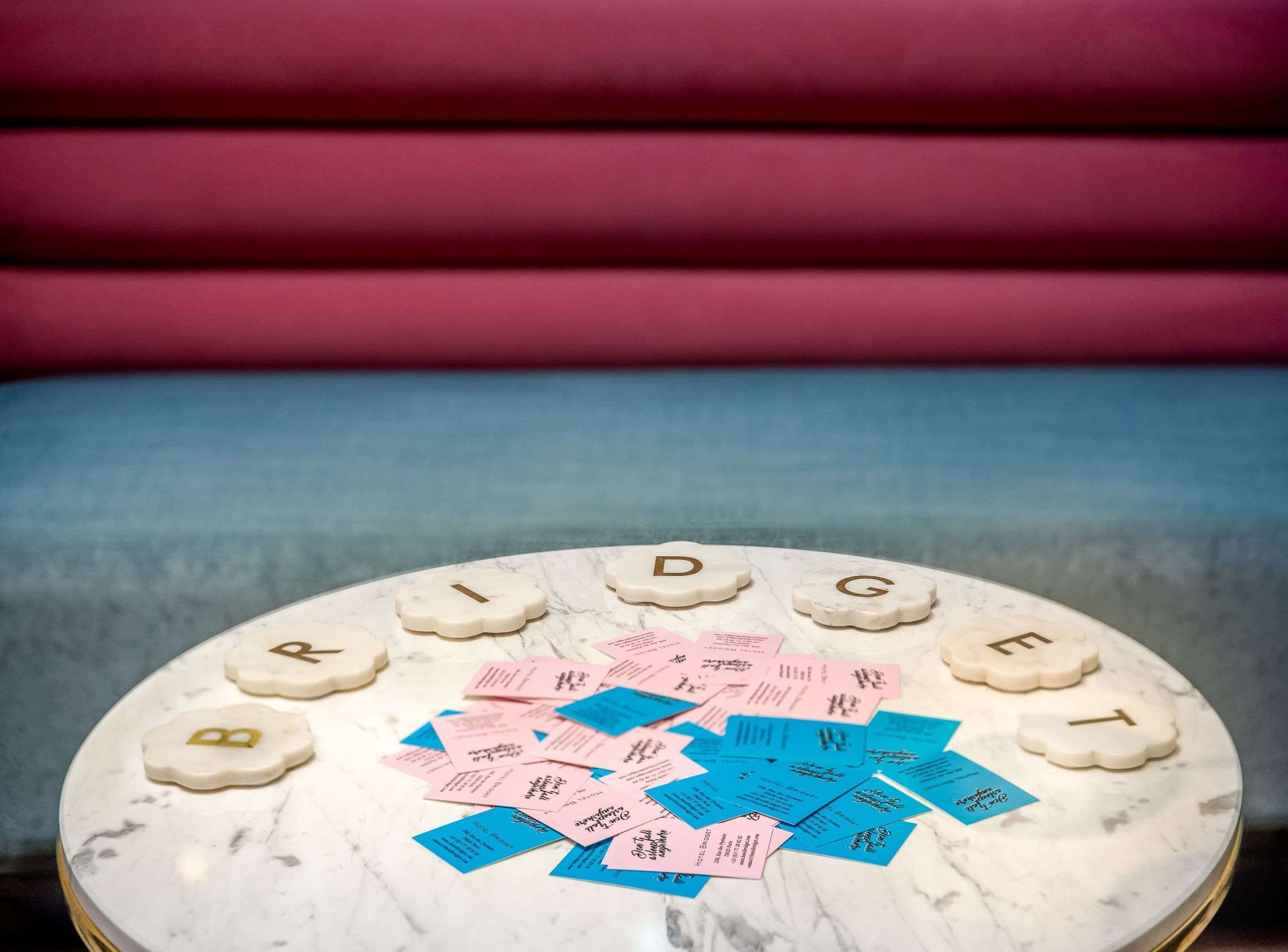 A round marble table with the name "BRIDGET" spelled out in letter-shaped tiles.