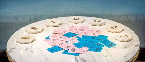 A round marble table with the name "BRIDGET" spelled out in letter-shaped tiles.