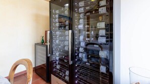 A wine cellar with glass doors and shelves of wine bottles. - L'Orée du Bois Bourgogne - Adults Only (Saint-Nicolas-lès-Cîteaux)