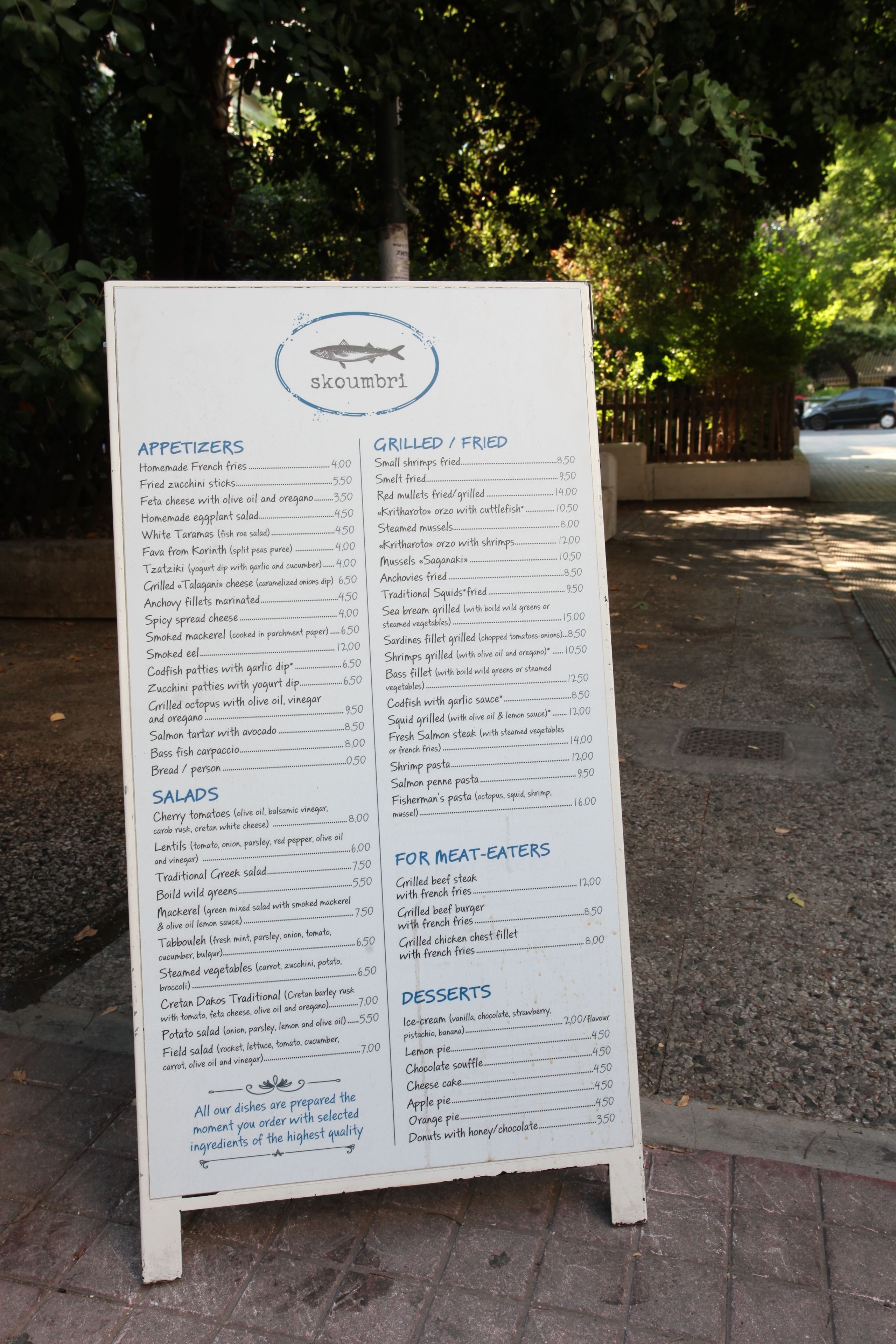 A menu board for a restaurant with various food categories and prices listed.