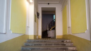 A staircase with a handrail leading to a landing. - METRO Apartment (Prague)