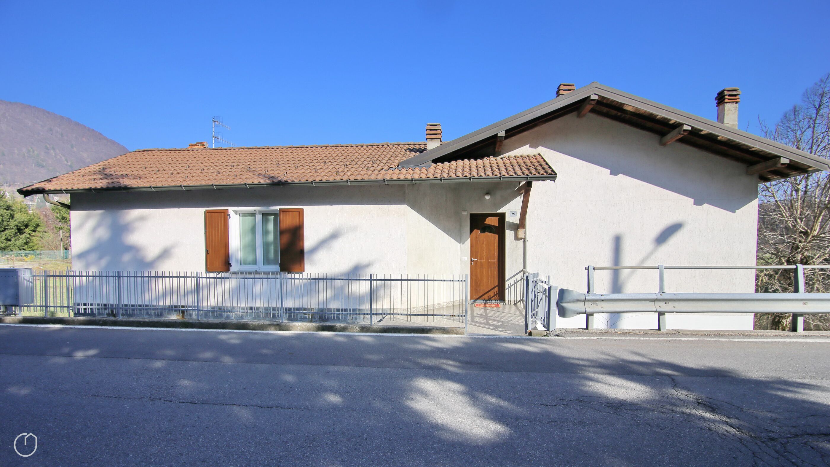 A small, single-story building with a tiled roof and a white exterior.