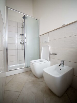 Chambre Quadruple, balcon | Salle de bain | Douche, sèche-cheveux, bidet, serviettes fournies