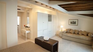 A hotel room with a bed, a desk, a wardrobe, a sofa, and a lamp. - Marina Di Savoca (Santa Teresa di Riva)
