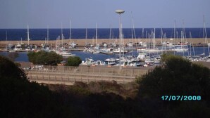 A marina with numerous sailboats docked, a clear sky, and a date stamp of 17/07/2008. - Head of four terraced houses (Porto Corallo)