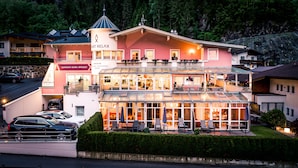 A multi-story building with a prominent sign for a sauna and infrared room. - Apart Relax (Laengenfeld)