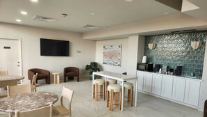 A modern interior with a dining area, kitchen, and seating.
