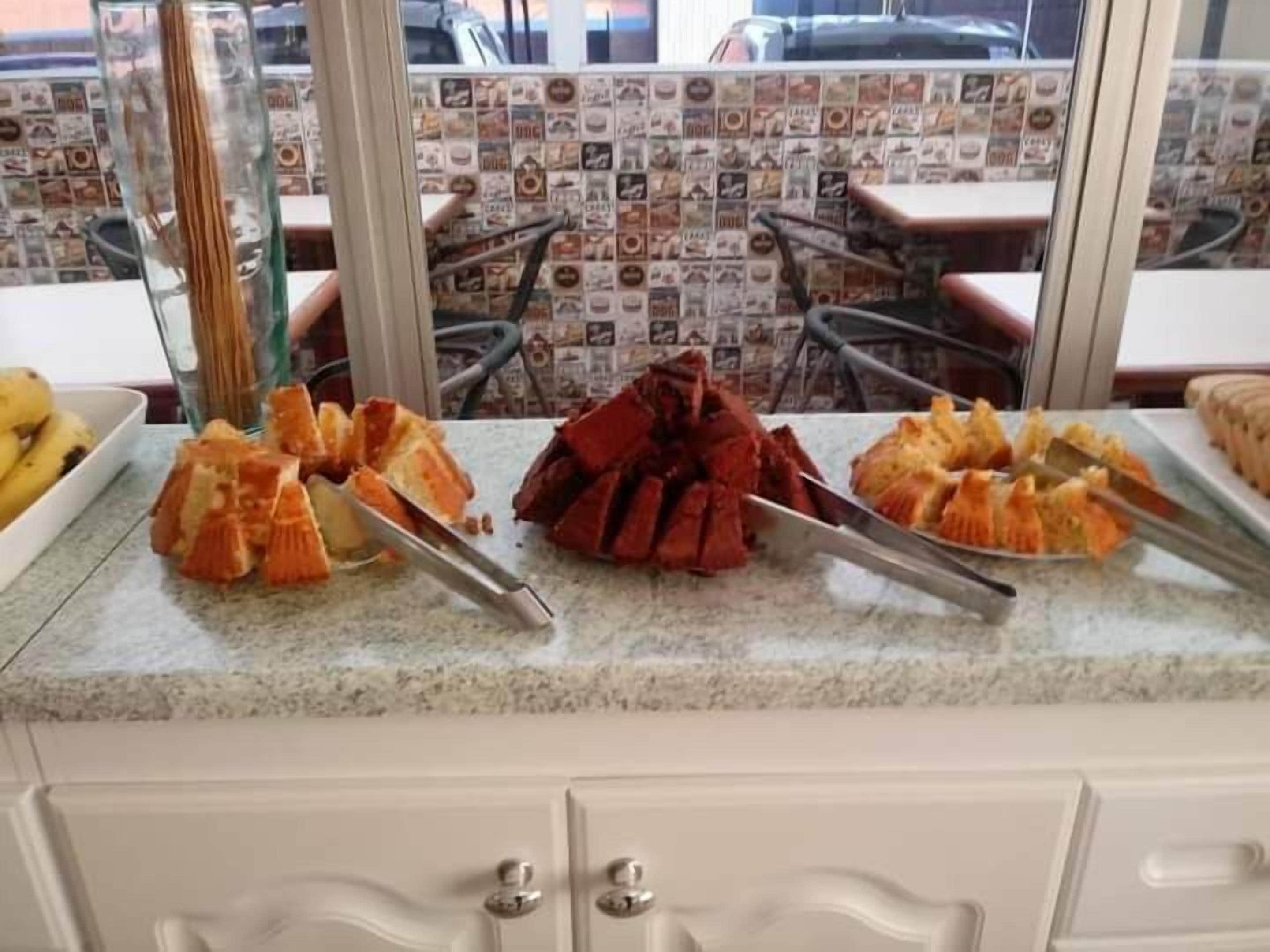 A kitchen counter with various food items and utensils.