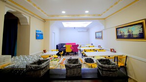 A dining area with tables and chairs, a buffet with food items, and a ceiling with decorative moldings. - Grand FM Hotel (Istanbul)