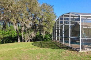 Situated in a serene natural setting, this greenhouse offers a tranquil space for gardening and plant cultivation.