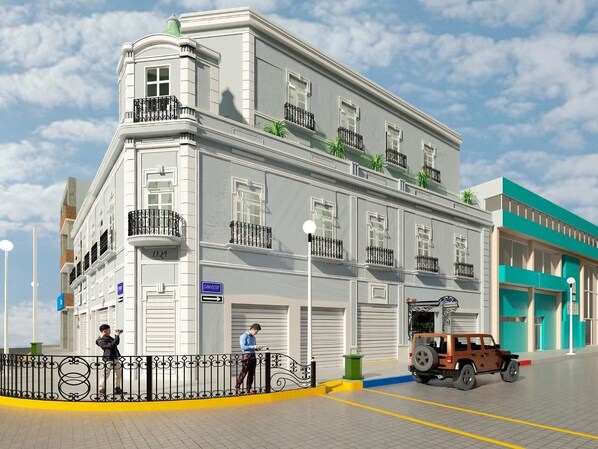 A building with a classic architectural style, featuring multiple windows and balconies. - Hotel Estancia Real (Tepatitlan de Morelos)