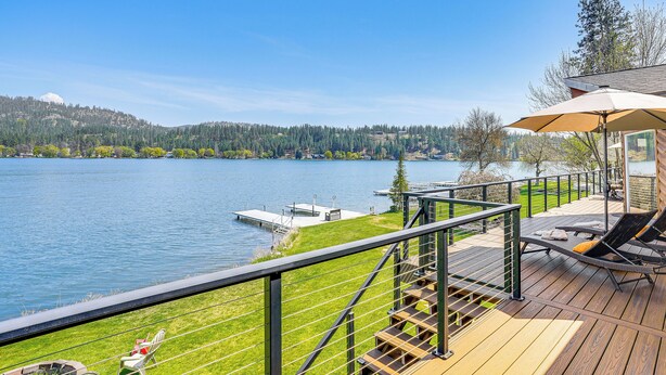 A deck with outdoor seating, a view of a lake, and a dock. - Lakefront Retreat w/ Kayaks, Paddle Boards & Deck! (Nine Mile Falls)