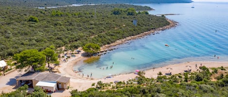 On the beach, sun-loungers