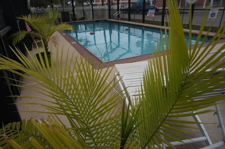 Seasonal outdoor pool, open 9:00 AM to 9:00 PM, pool umbrellas. Riverside Hotel